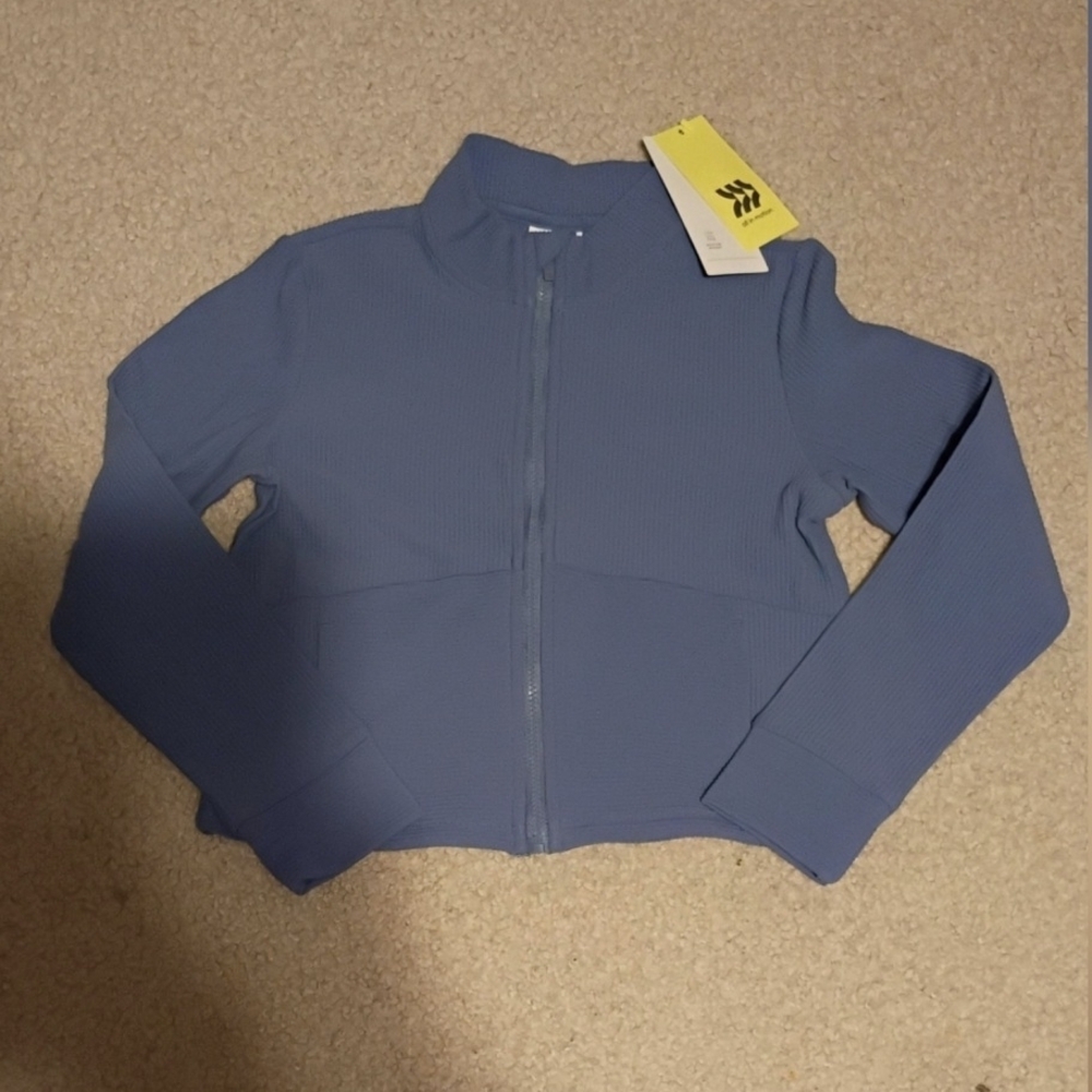 all in motion Blue and Cream Clothing Label